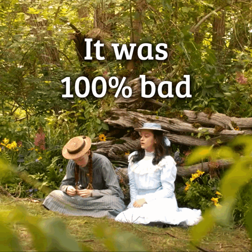 Two Girls Sitting In The Grass With The Words It Was 100 % Bad Below Them GIF