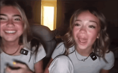 Two Girls Sitting Smiling