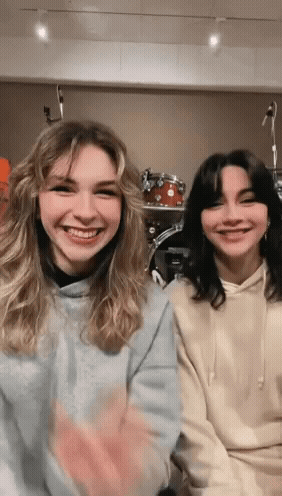 Two Girls Smiling at Drum Set