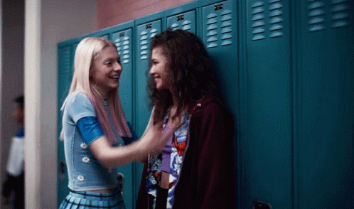Two Girls Standing In Front Of Blue Lockers GIF