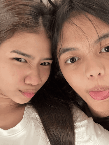Two Girls Sticking Their Tongues Out And Making Faces GIF