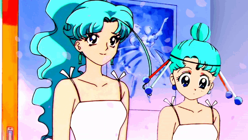 Two Girls With Blue Hair Are Standing In Front Of A Picture GIF