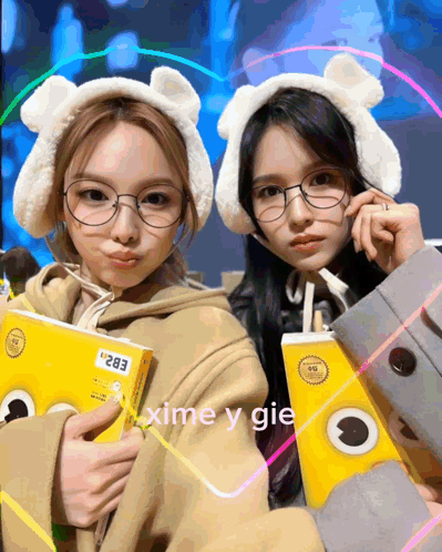 Two Girls With Glasses Ear Muffs Holding Boxes 283