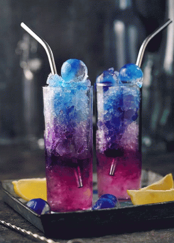 Two Glasses Of Blue And Purple Drinks With Straws GIF