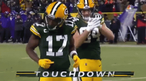 Two Green Bay Packers Players Celebrate A Touchdown On The Field GIF