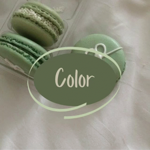 Two Green Macarons In A Plastic Container With A Green Circle That Says Color GIF