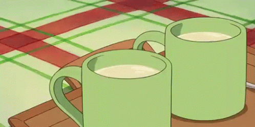 Two Green Mugs Of Milk Are Sitting On A Wooden Tray On A Table . GIF