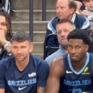 Two Grizzlies Basketball Players Are Sitting In The Stands GIF
