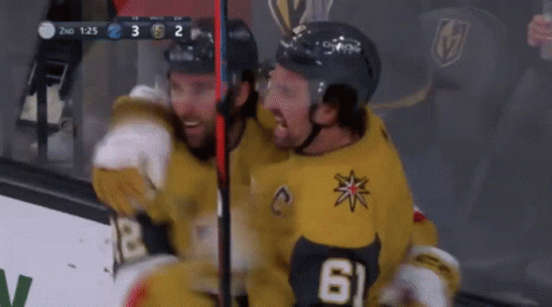 Two Hockey Players Are Hugging Each Other And One Has The Number 61 On His Jersey GIF