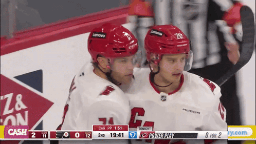Two Hockey Players Hugging Scoreboard Cash GIF