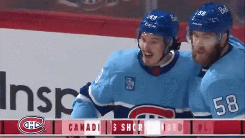 Two Hockey Players in Blue Uniforms