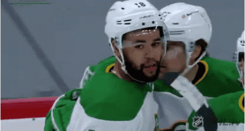 Two Hockey Players Kissing Cheek
