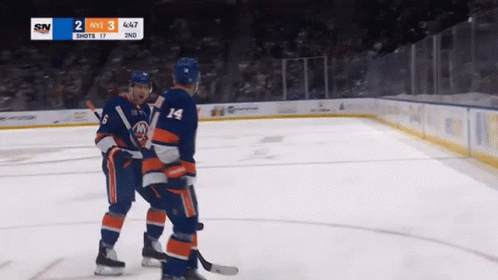 Two Hockey Players On The Ice With A Scoreboard That Says Sn On It GIF
