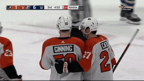 Two Hockey Players One Of Whom Has The Number 2 On Their Jersey GIF
