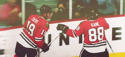 Two Hockey Players One Of Whom Has The Number 88 On His Back GIF