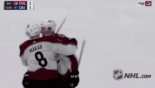 two hockey players shaking hands in front of a nhl logo