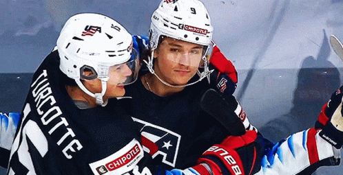 Two Ice Hockey Players One Of Whom Has The Number 21 On His Jersey GIF