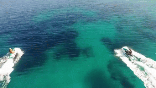 Two Jet Skis Are Floating In The Ocean GIF