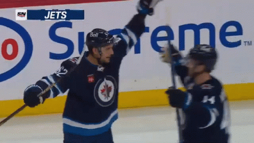 Two Jets Players Celebrate Goal In Front Of Supreme Ad GIF