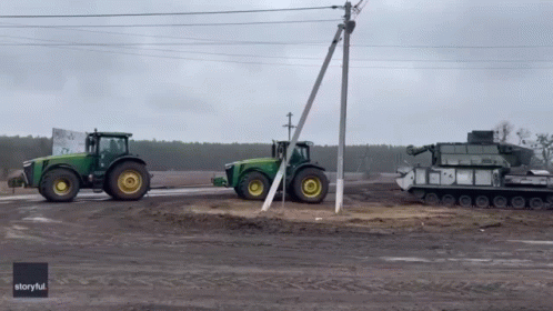 Two John Deere Tractors Parked Next to Each Other