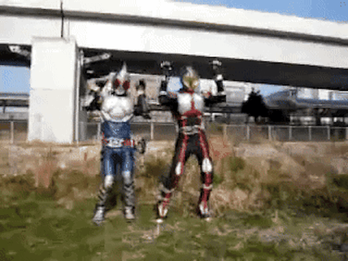 Two Kamen Riders Jumping in Front of Bridge
