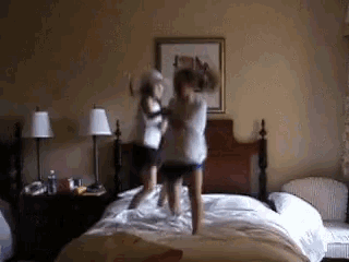Two Kids Jumping On The Bed GIF