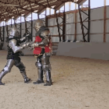 Two Knights In Armor Are Standing In A Building GIF