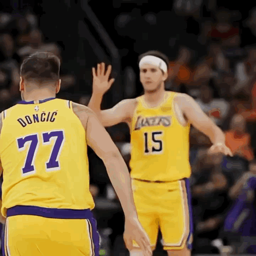 Two Lakers Basketball Players High Five Each Other During A Game GIF