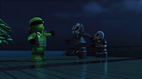 Two Lego Figures Are Standing Next To Each Other In The Dark GIF