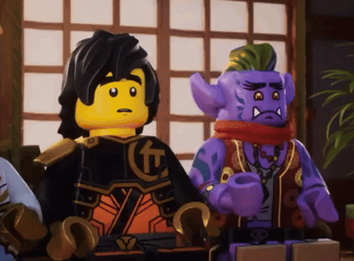 Two Lego Figures Sitting Next To Each Other GIF