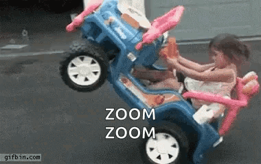 Two Little Girls Are Riding In A Toy Car With The Words Zoom Zoom On The Bottom . GIF