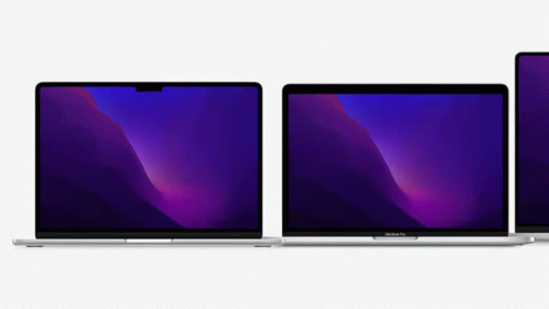 Two Macbook Pro Laptops Are Sitting Next To Each Other On A White Surface . GIF