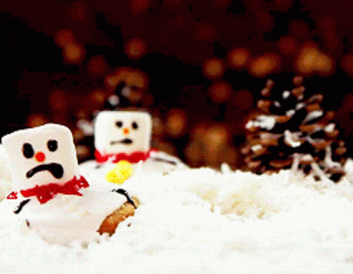 Two Marshmallow Snowmen With Sad Faces Are In The Snow GIF