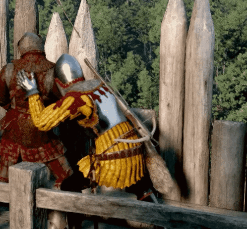Two Medieval Soldiers Standing by Wooden Fence
