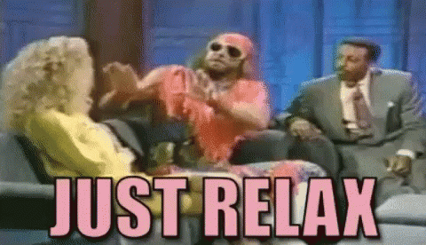 Two Men And A Woman Are Sitting On A Couch With The Words Just Relax Above Them . GIF