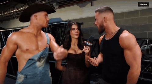 two men and a woman are talking with a microphone that says raw