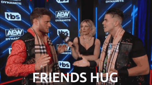 Two Men and Woman Talking Near Friends Hug Sign