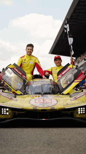 Two Men and Yellow Orlen Race Car