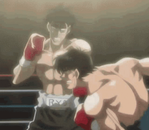 Two Men Are Boxing In A Ring And One Of Them Is Wearing Red Gloves . GIF