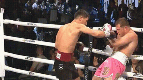 two men are boxing in a ring that has hennessy branded ropes