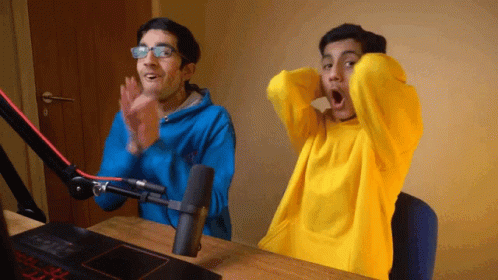 Two Men Are Clapping In Front Of A Microphone And One Of Them Is Wearing A Yellow Sweater GIF