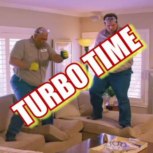 two men are dancing in a living room with turbo time written on the sign