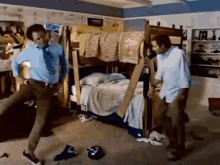 Two Men Are Dancing In A Room With A Bunk Bed In The Background GIF