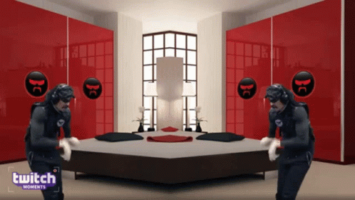 Two Men Are Dancing In Front Of A Bed In A Room With A Twitch Logo GIF