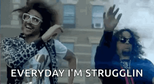 Two Men Are Dancing In Front Of A Building And One Of Them Is Wearing Sunglasses And A Leopard Print Jacket . GIF