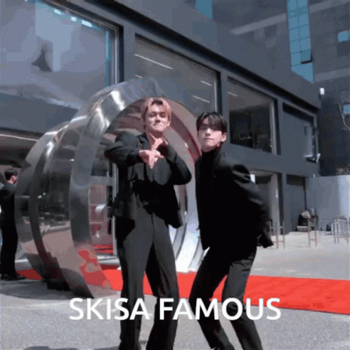 Two Men Are Dancing In Front Of A Building With The Words " Skia Famous " GIF