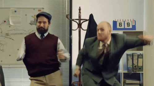 Two Men Dancing In Front Of Calendar GIF