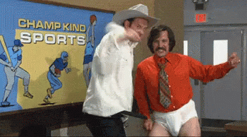 Two Men Are Dancing In Front Of A Painting That Says Champ Kind Sports GIF