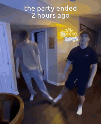 Two Men Are Dancing In Front Of A Sign That Says Corona GIF