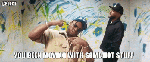 Two Men Are Dancing In Front Of A Wall With The Words You Been Moving With Some Hot Stuff GIF